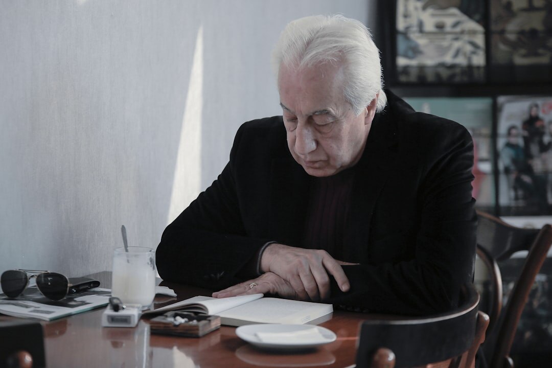 elderly man writing book