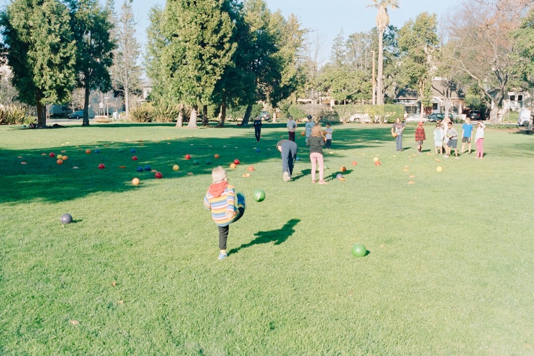 Seniors doing a gentle group exercise class outdoors in a park