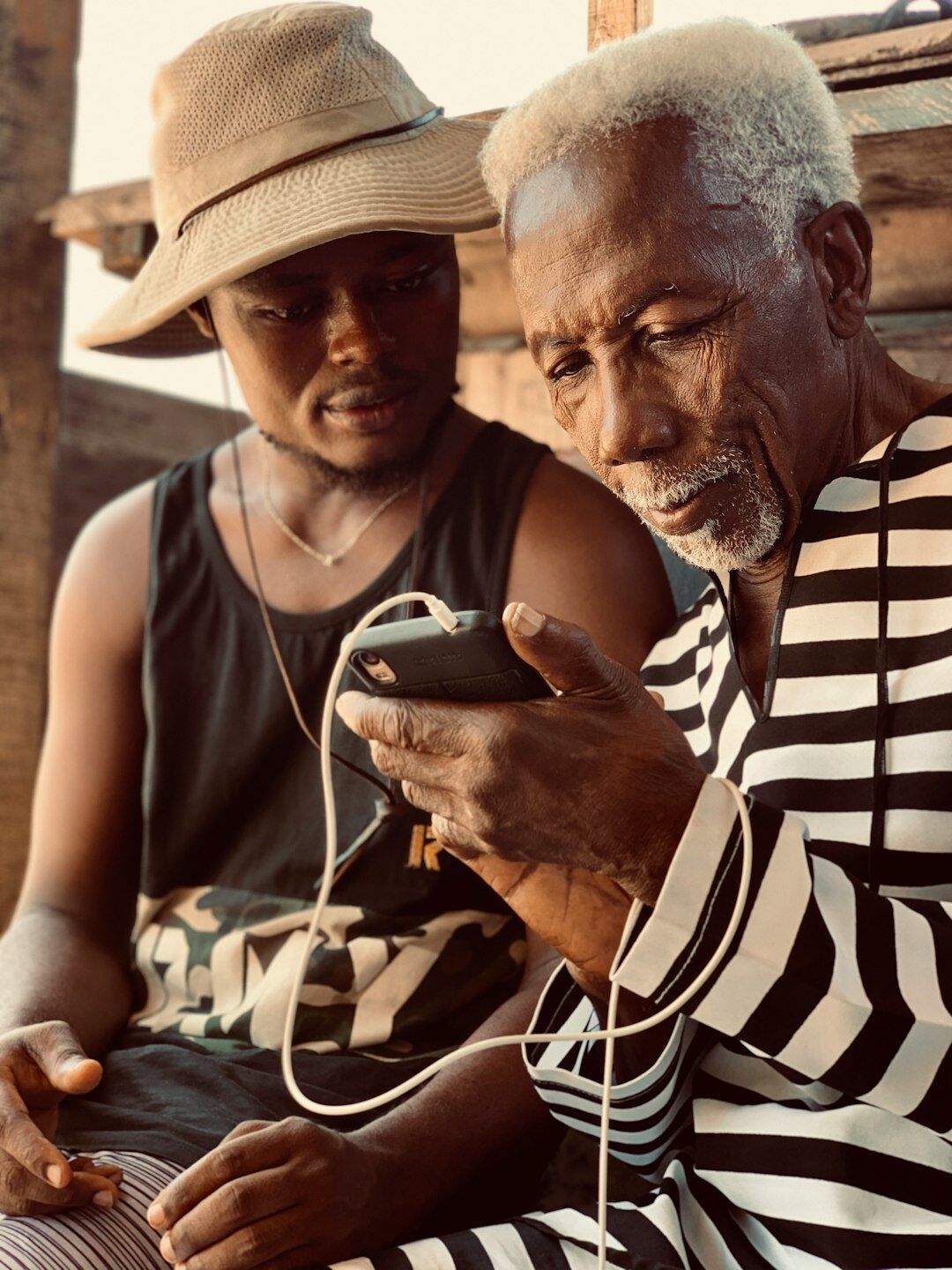 Young volunteer helping a senior use a smartphone